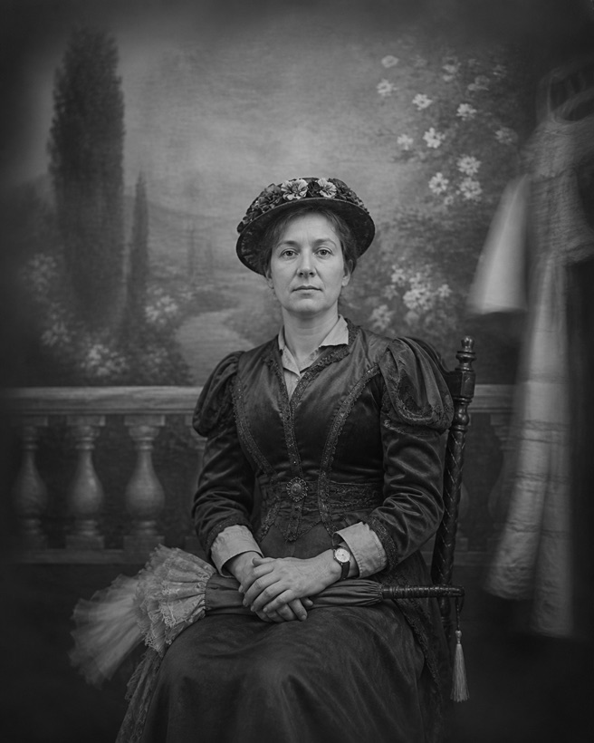 Dolores Vane, seated, perfectly still